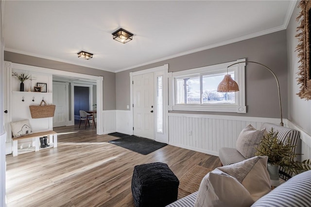 foyer entrance with ornamental molding and hardwood / wood-style flooring