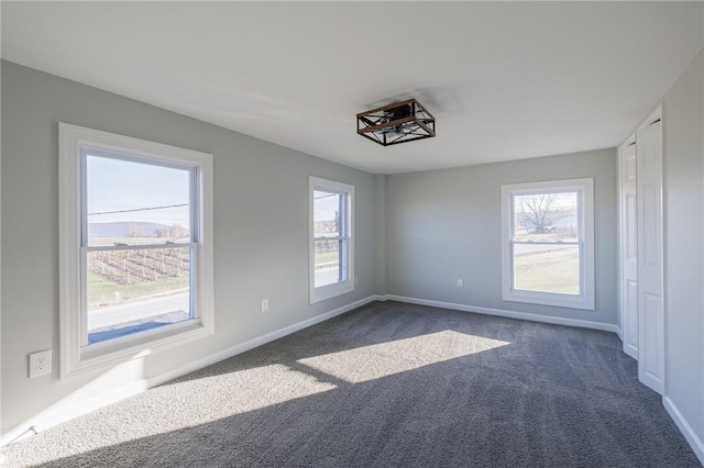 carpeted empty room featuring a healthy amount of sunlight