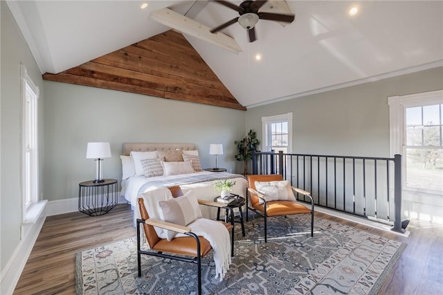 bedroom with hardwood / wood-style flooring, high vaulted ceiling, multiple windows, and ceiling fan