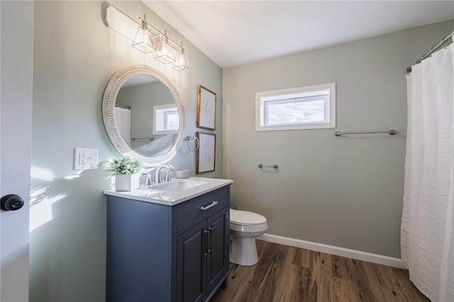 bathroom with hardwood / wood-style floors, vanity, and toilet