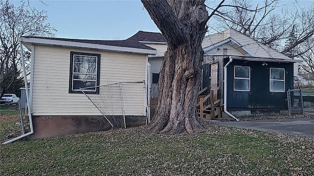 view of side of home with a lawn and a patio area