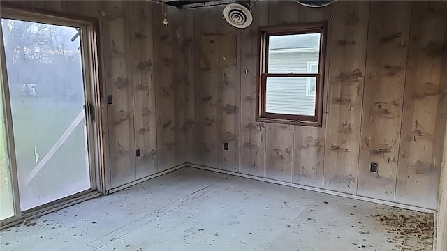 unfurnished room with wooden walls