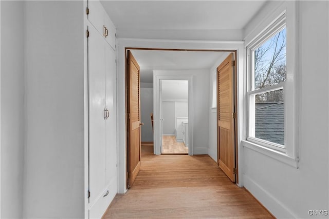 corridor with light wood-type flooring