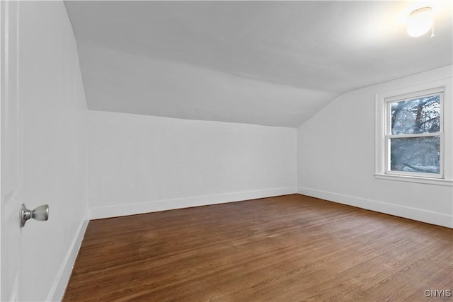 bonus room with wood-type flooring and lofted ceiling