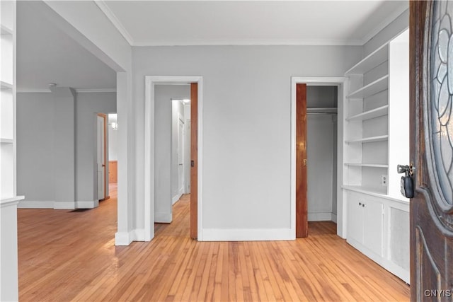 unfurnished bedroom featuring light hardwood / wood-style flooring, a closet, and crown molding