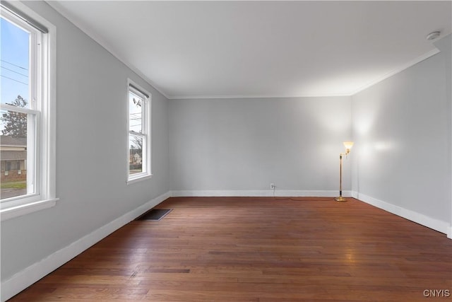 spare room with crown molding and dark hardwood / wood-style flooring