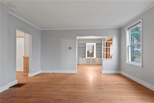 unfurnished room featuring crown molding and light hardwood / wood-style flooring