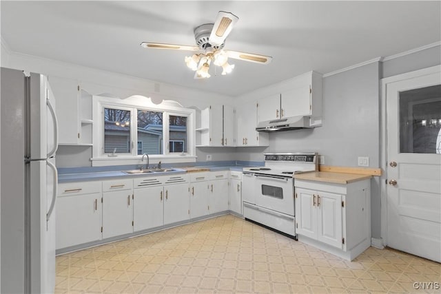 kitchen with ceiling fan, sink, crown molding, white appliances, and white cabinets