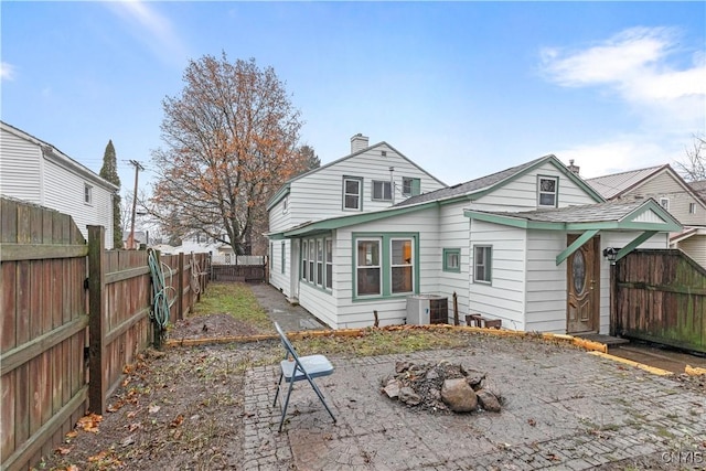 rear view of property featuring central AC