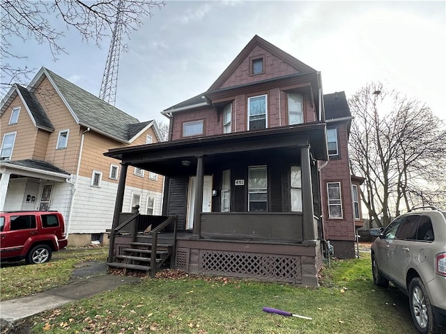 view of front of home with covered porch and a front yard