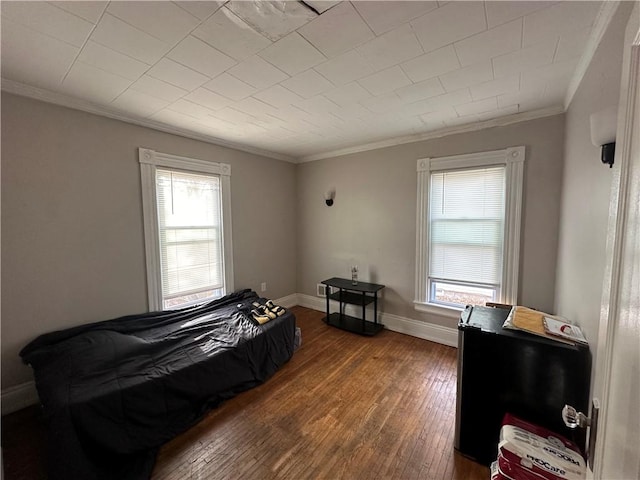 bedroom featuring dark hardwood / wood-style floors and crown molding