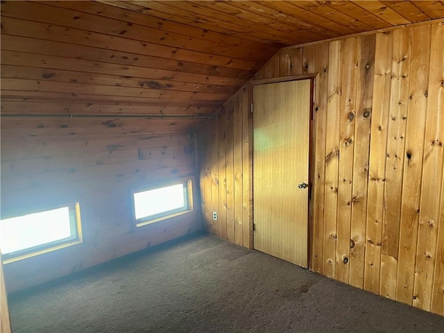 bonus room with carpet flooring, vaulted ceiling, wooden ceiling, and wood walls