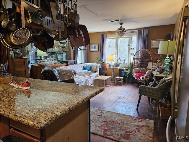 interior space with ceiling fan and dark wood-type flooring