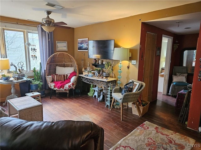 living room with ceiling fan and dark hardwood / wood-style floors