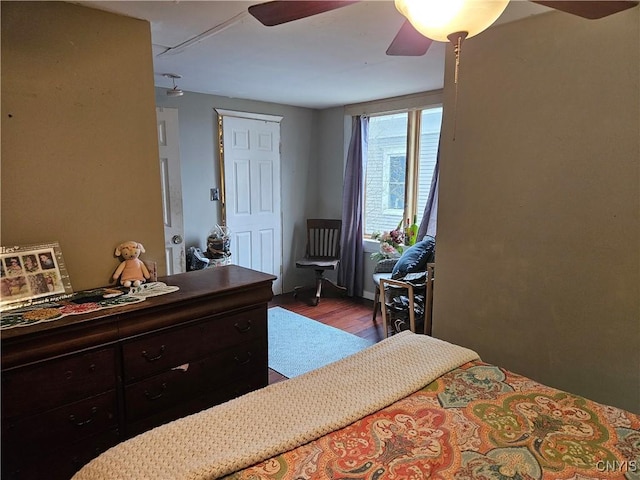 bedroom with dark hardwood / wood-style floors and ceiling fan