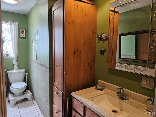 bathroom featuring tile patterned flooring, vanity, and toilet