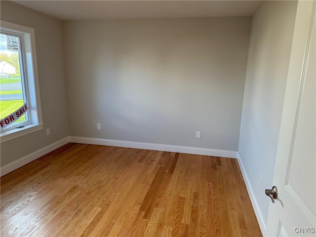 empty room with light hardwood / wood-style flooring