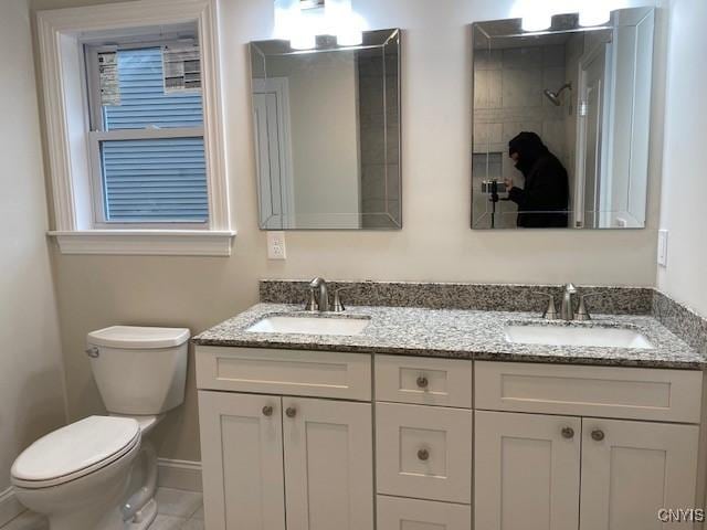 bathroom with tile patterned floors, vanity, and toilet