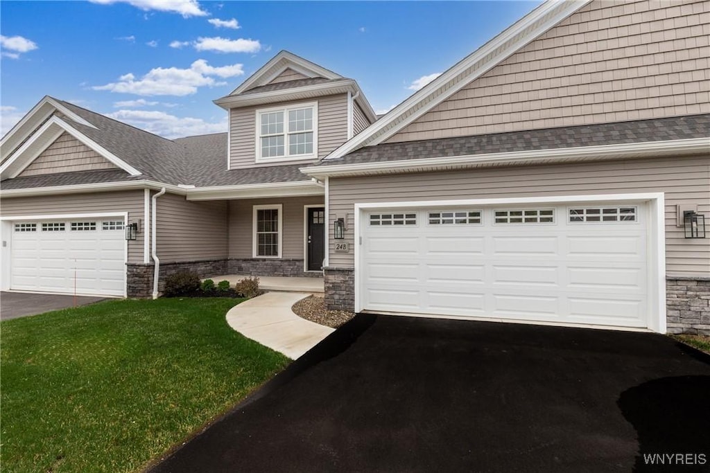 craftsman-style home with a garage and a front lawn