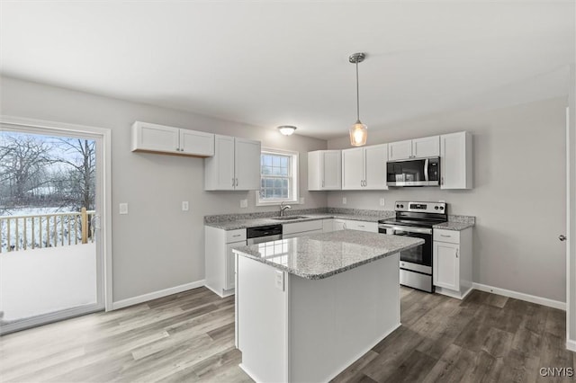 kitchen with plenty of natural light, white cabinetry, and stainless steel appliances