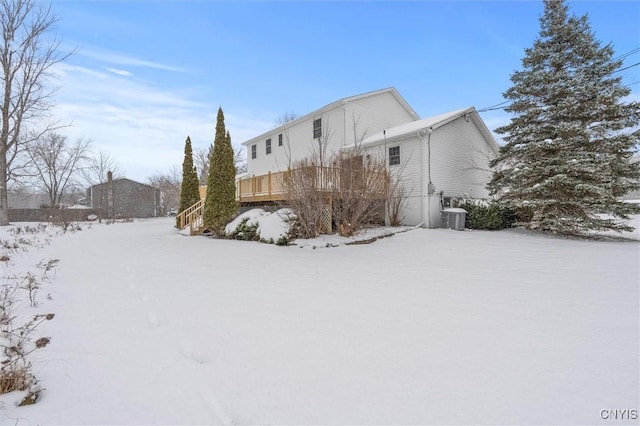 view of snow covered exterior with central AC unit