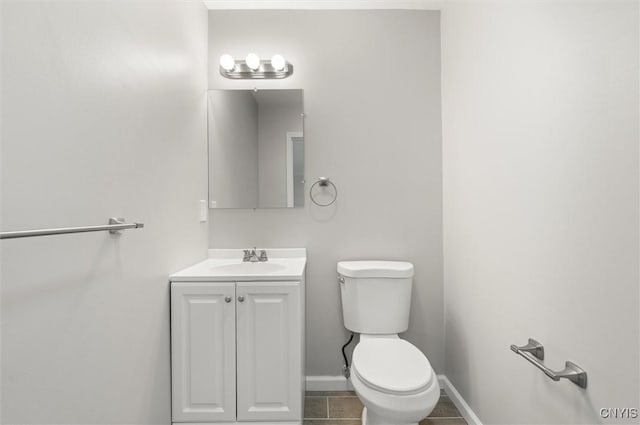 bathroom featuring tile patterned flooring, vanity, and toilet