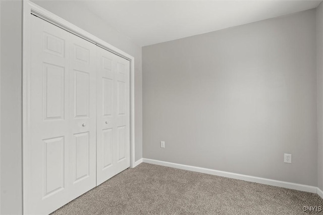 unfurnished bedroom featuring carpet floors and a closet