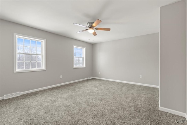 spare room featuring ceiling fan and carpet floors