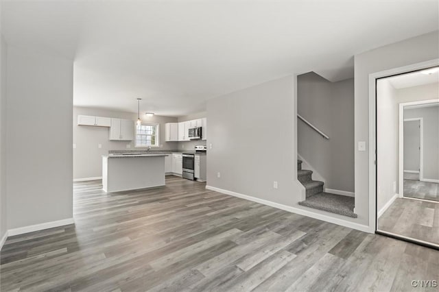 unfurnished living room with light wood-type flooring