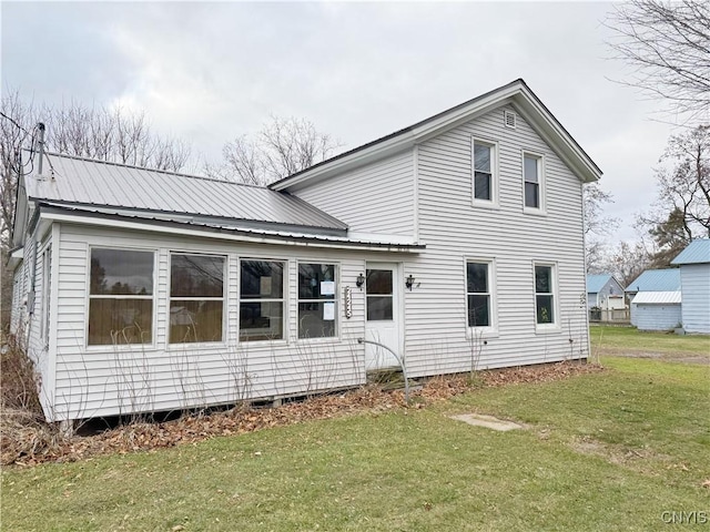 rear view of property with a lawn