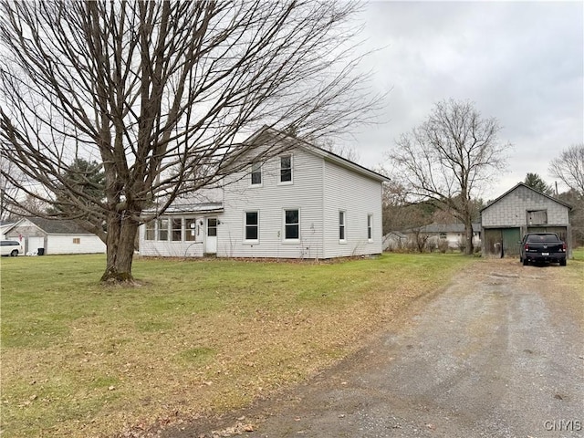 exterior space with a yard, a garage, and an outdoor structure