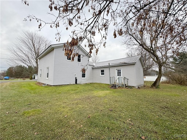 rear view of house with a yard