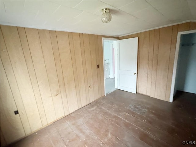 unfurnished bedroom with wood walls