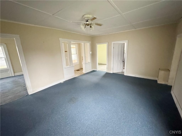 unfurnished room featuring dark colored carpet and ceiling fan