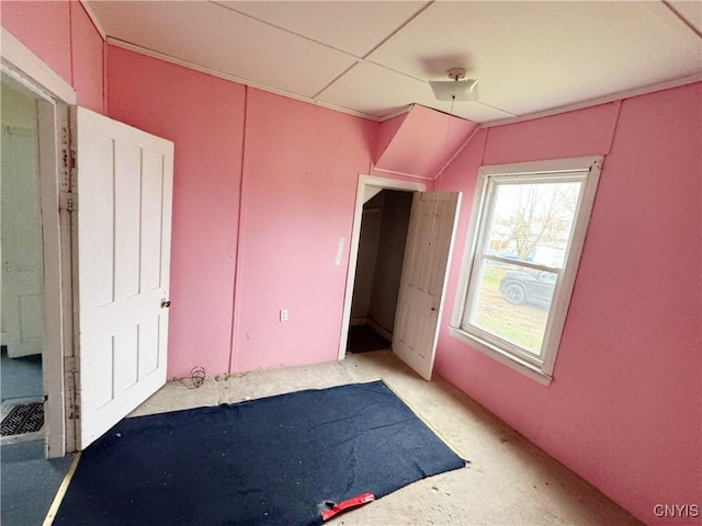 unfurnished bedroom with lofted ceiling