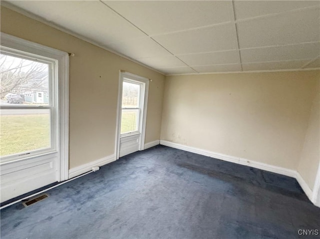 spare room with dark colored carpet