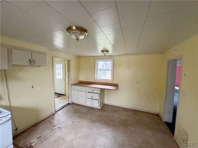 kitchen with built in desk and white cabinetry