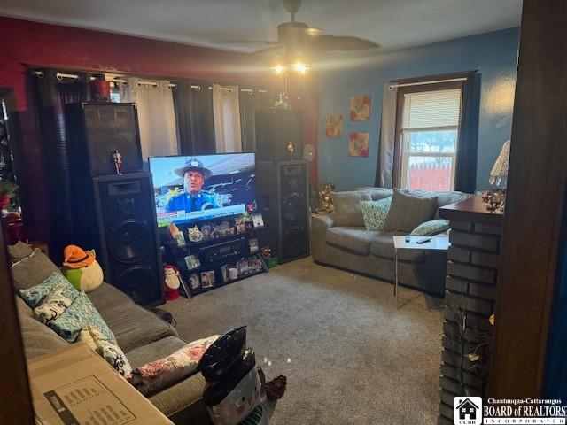 living room with ceiling fan and carpet floors