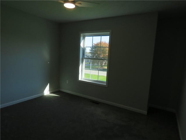 carpeted spare room with ceiling fan