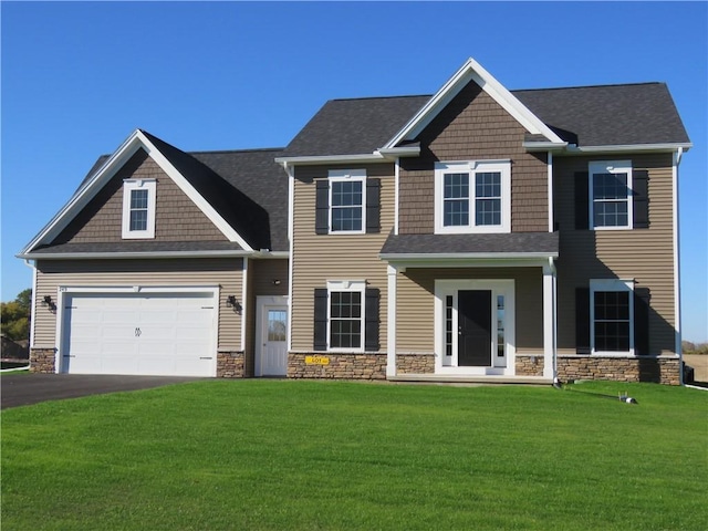 view of front facade with a garage and a front lawn