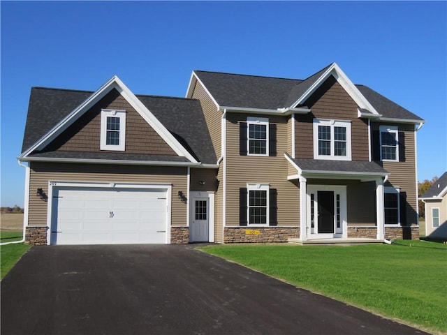 craftsman inspired home with a garage and a front lawn