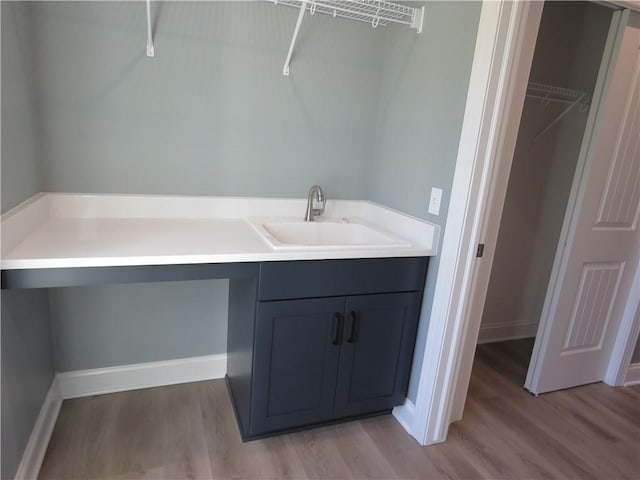 laundry room featuring sink and light wood-type flooring