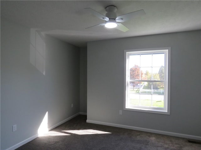 carpeted empty room featuring ceiling fan