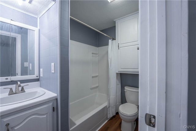 full bathroom with wood-type flooring, vanity, toilet, and shower / bath combo with shower curtain