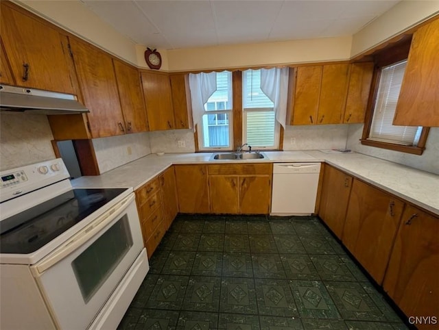 kitchen with decorative backsplash, sink, and white appliances