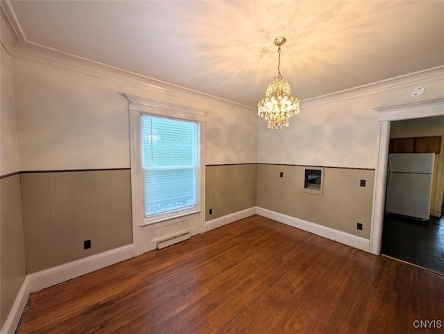 empty room with a chandelier, crown molding, and dark wood-type flooring