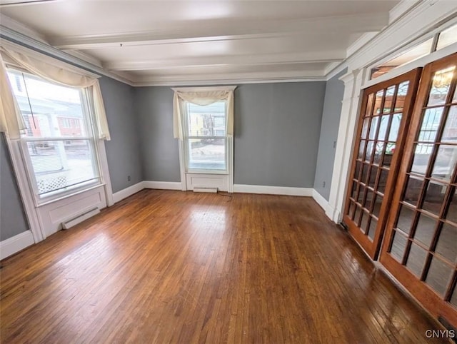 spare room with beamed ceiling, dark hardwood / wood-style flooring, crown molding, and a baseboard radiator