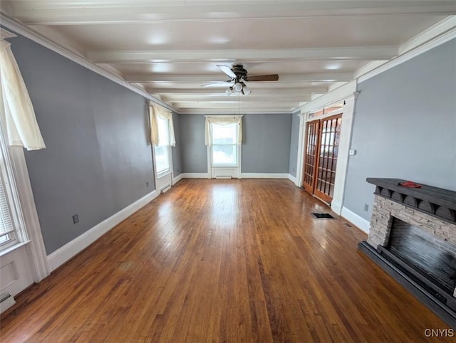 unfurnished living room with ceiling fan, beamed ceiling, crown molding, hardwood / wood-style floors, and a fireplace