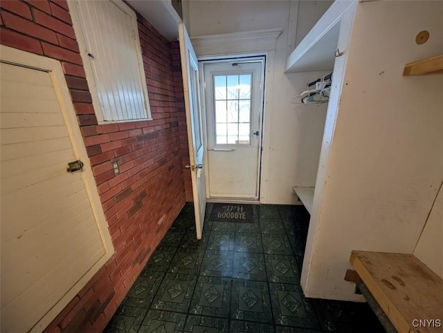 entryway featuring brick wall