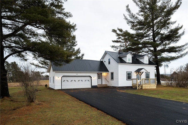 new england style home with a front lawn and a garage